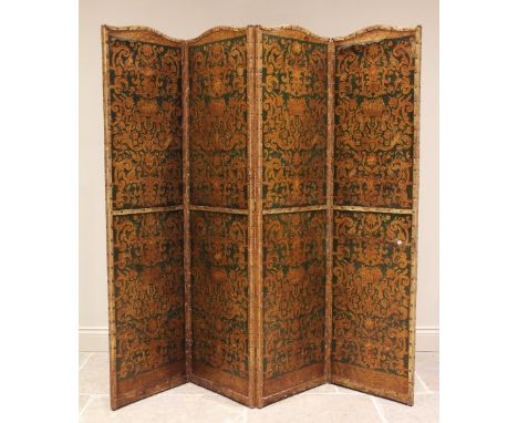 An early 20th century three fold leather room screen, the four panels embossed with a classical scrolling foliate design, emb
