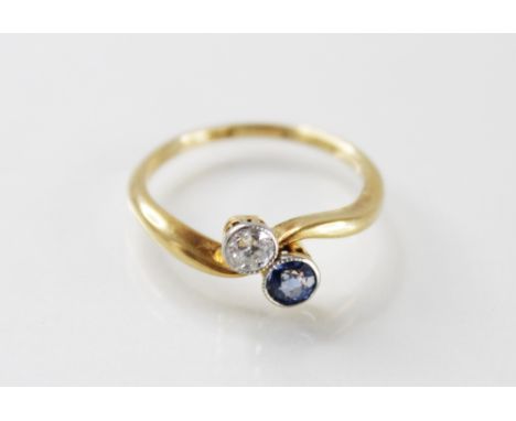 A sapphire and diamond two-stone ring, comprising a round old diamond and a round mixed cut sapphire, each 3.5mm diameter, co