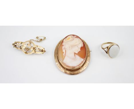 A 9ct gold carved shell cameo brooch, the central oval cameo depicting the profile of a woman, set to a 9ct gold border surro