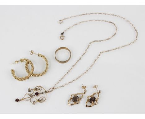 An Edwardian garnet and seed pearl set 9ct gold pendant, 43mm long, suspended on a gold coloured unmarked chain, 43cm long, t