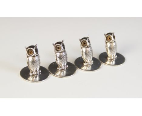 A set of four George V novelty silver place-card holders, Sampson Mordan & Co, London 1927, each modelled as an owl with feat
