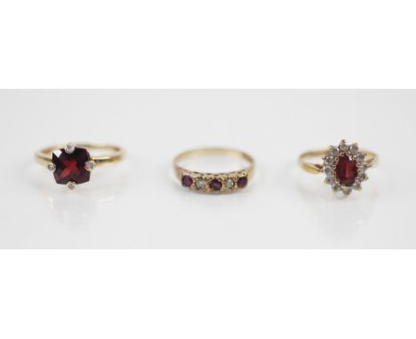 A garnet and diamond ring, comprising a central square mixed cut garnet measuring 8mm x 8mm, diamond set claws, to a plain po