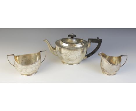 An Edwardian silver tea service, Barker Brothers, Chester 1906, comprising teapot, sucrier and milk jug, each of oval form wi