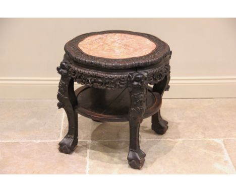 A Chinese hardwood and marble urn stand, late 19th/early 20th century, the circular scalloped top inset with a rouge marble s