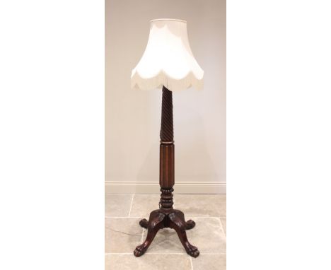 A 19th century style mahogany standard lamp, early 20th century, the wrythen and vertically lobed column raised upon four cab