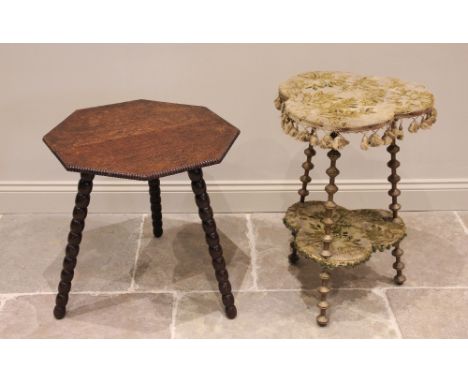 A late 19th century two tier gilt wood gypsy table, the trefoil table top covered in foliate fabric with a hanging tassel bor