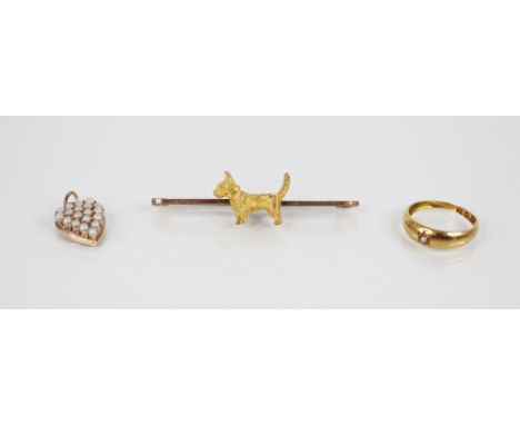 A Scottish Terrier bar brooch, the central gold coloured terrier figure with realistic fur effect chasing, surmounted on a 9c