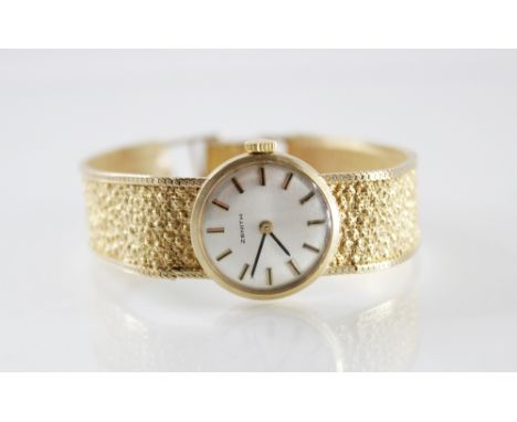 A lady's vintage Zenith 9ct gold wristwatch, the round cream toned dial with baton markers, plain polished outer case, 22mm d