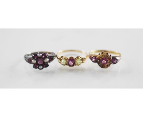 An early 20th century pink-stone set 18ct gold ring, comprising a central mixed cut pink gemstone  with a cluster surround of