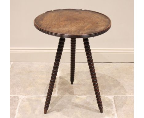 A George III mahogany gypsy table, the circular table top with a reeded edge and moulded rim, raised upon associated bobbin t