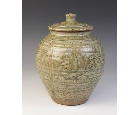 A Jim Malone (b.1946) stoneware vase and cover in green ash glaze, of inverted baluster form, the ribbed body divided into th