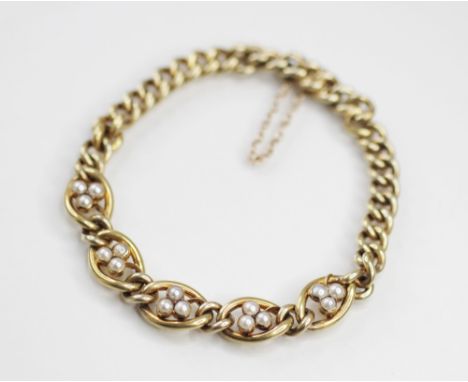 An early 20th century pearl set curb link bracelet, comprising five central clover motif panels set with half cultured pearls