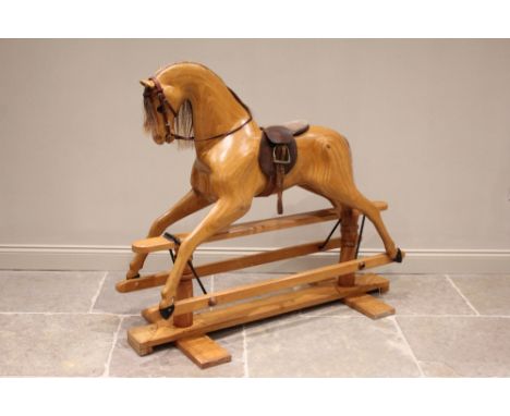 A Relko laminated wooden rocking horse, late 20th century, with a natural wooden finish, applied with horse hair mane and tai