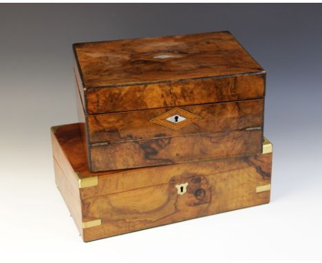 A mid 19th century burr walnut stationary box, applied with brass corner brackets and centred with a shield shaped cartouche,