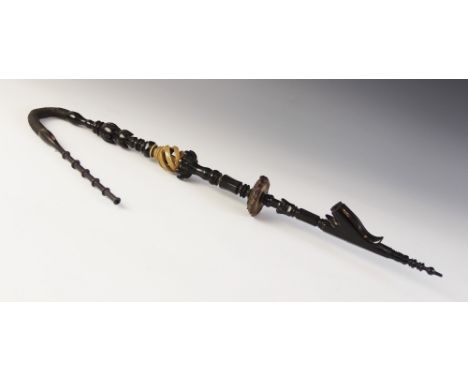 A carved ebony Bavarian smoking pipe, with ring turned mouth piece, carved and turned body with stylised floral knops, an ope