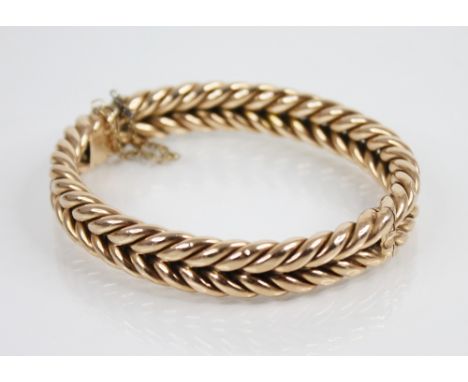 A Victorian 15ct gold woven-link bangle, tongue and box snap clasp fastening, 7.2cm x 6.3cm, weight 34.8gmsCR; Width of bangl