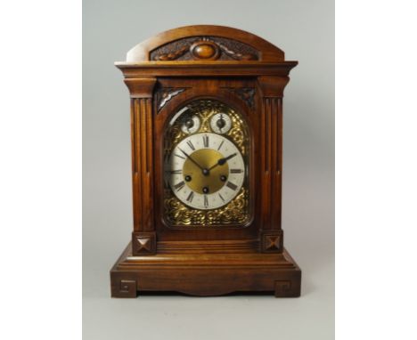 A German walnut mantel clock, 19th century, the case of architectural form, with silvered Roman numeral chapter ring, chime/s