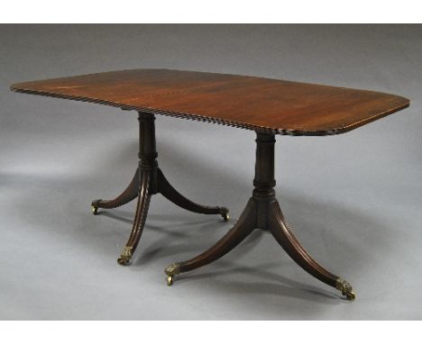 A George III style mahogany D end dining table, 20th century, the top with reeded edge, on turned supports, with streading tr