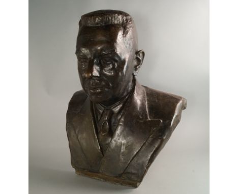 A bronze portrait bust of a man, 20th century, dressed in a suit and tie, 58cm high

