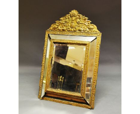 A cushion framed gilt metal mirror, 20th century, foliate top, 137cm high x 86cm wide.  