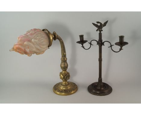 A patinated metal twin light candelabra, 20th century, the column surmounted with an eagle finial, the lights with adjustable
