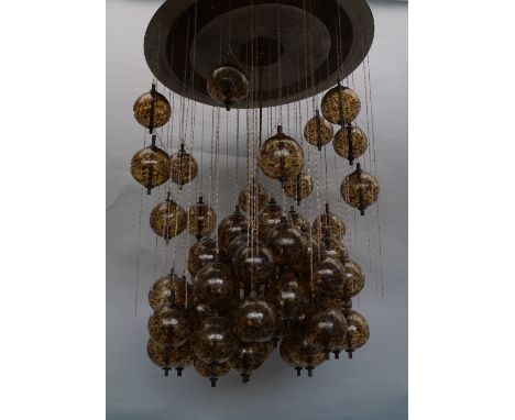 A large and impressive modern designed ceiling light, 20th century, the corona of polished metal, hung with multiple glass sp