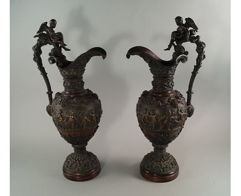 A pair of French bronze ewers, late 19th/early 20th century, moulded in the Renaissance taste, with scrolling handles mounted