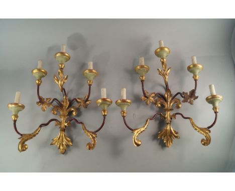 A pair of painted and gilt metal five light wall appliques, Italian, early 20th century, overall applied with foliage, 52cm h