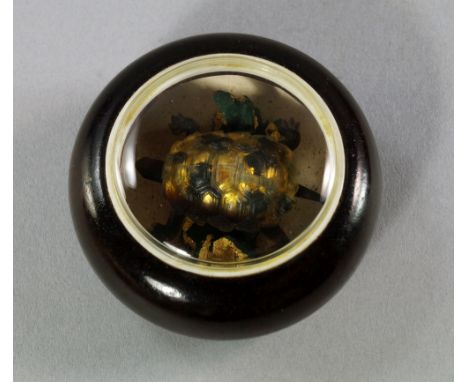 A Japanese manju netsuke, late 19th/early 20th century, of wooden body, the centre inset with an articulated turtle,  4.5cm d