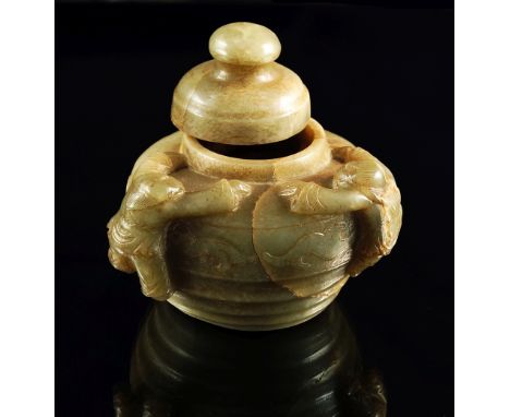 A Chinese jade vase and cover, 19th century, carved with a ridged body and bands of archaic decoration, with two boys climbin