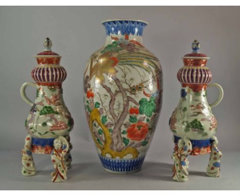 A pair of Japanese style porcelain hot water urns, possibly of European origin, late 19th/20th century, the lids with flame f
