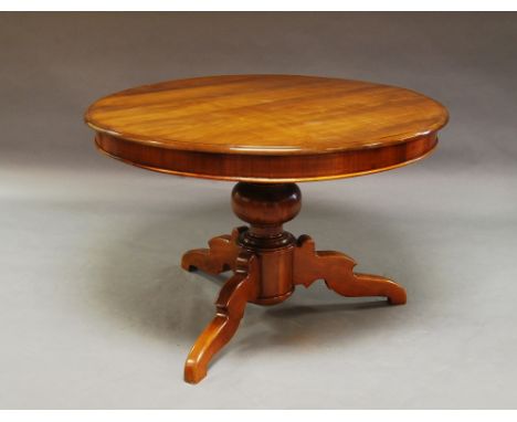 A circular mahogany breakfast table, raised on tripod legs, 75cm high x 115cm diam. 