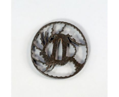 A Japanese bronze tsuba, 18th/19th century, pierced with cherry blossom branches and engraved with flower heads, 7.5cm diamet