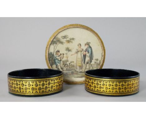 A pair of papier mache lacquered and gilded bottle coasters, 19th century, 11cm diameter, together with a circular metallic a