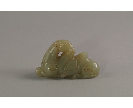 A Chinese jade model of a recumbent camel, in the Song/Ming style, modelled seated on its haunches, with seat cloth, 8.5cm wi