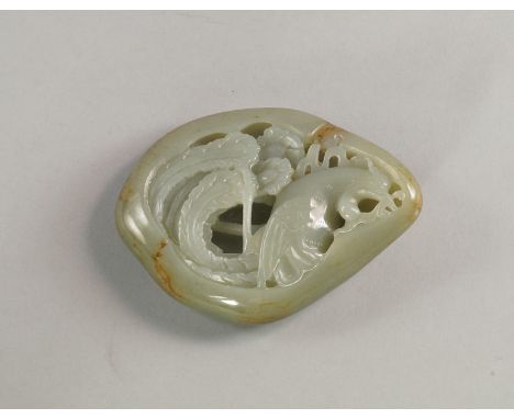 A Chinese green and mottled jadeite boulder carving, 20th century, pierced and decorated in relief with a phoenix with a curl