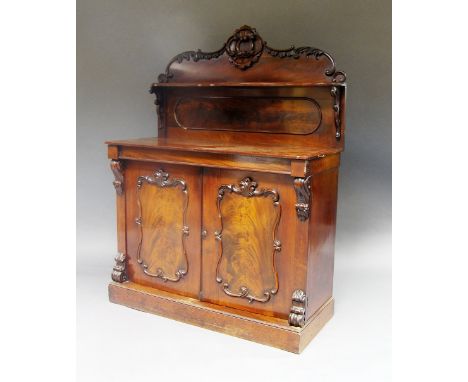 A Victorian mahogany chiffonier, 19th century, the foliate carved shelf super structure, above cupboard doors, plinth base, 1