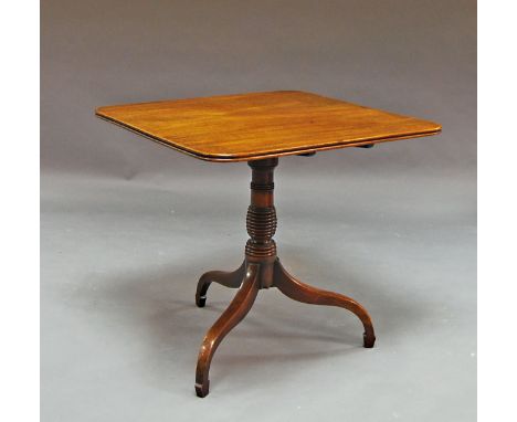 A mahogany flip top table, 19th century, the square top raised on tripod legs. 