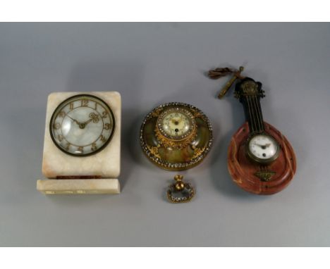 A French onyx and gilt metal mounted mantel clock, inset with jewels, the face with Arabic chapter ring, 14 cm wide; together