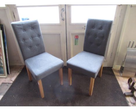 Pair of modern grey upholstered dining chairs with light wood supports (2) 