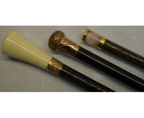 Three walking stick in dark wood, one engraved copper knob, one copper banding and concave bone top, one missing top 