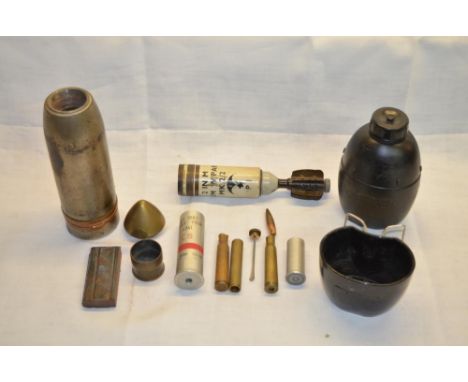 Collection of expended and deactivated military shell casings, vintage gun magazine, screw top oil bottle with applicator 