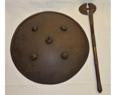 Large Indian steel Dahl type shield with central spike boss within a border of four further bosses, leather strap with detail
