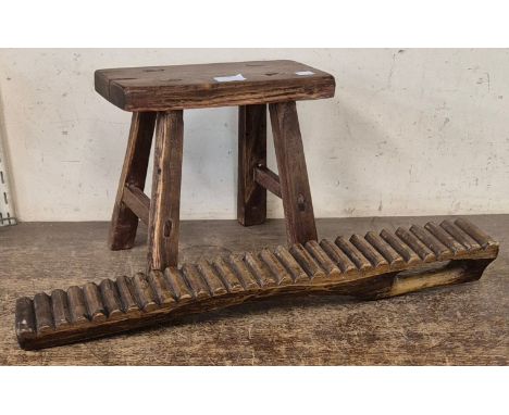 A Victorian style primitive elm stool and an African hardwood washboard 