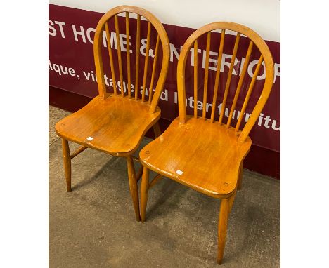 A pair of Ercol beech Blonde Windsor chairs 