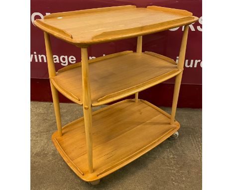 An Ercol Blonde elm and beech Windsor trolley 