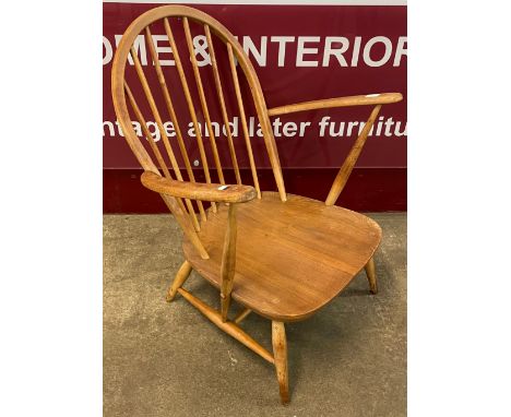 An Ercol Blonde elm and beech 305 model lounge chair 