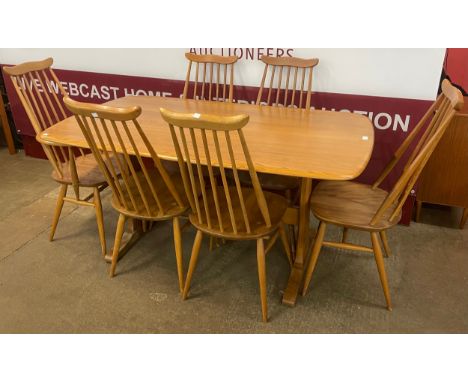 An Ercol Blonde elm Windsor dining table and six Goldsmith chairs 