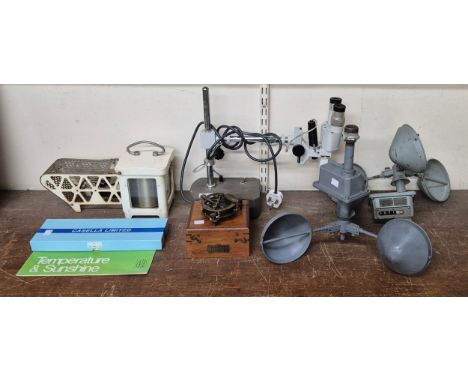 Assorted scientific instruments, including a thermograph weather station, compass, etc.