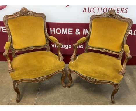 A pair of French Louis XV style walnut and fabric upholstered fauteuil chairs 